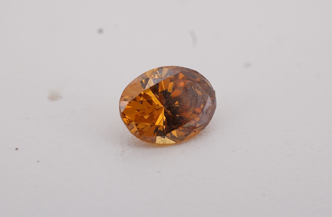 An unmounted Fancy Deep Brown-Orange diamond, the oval natural diamond measuring 5.3 x 3.9 x 2.5mm, with treated colour, weighing 0.34 carats, Accompanied by GIA report no. 6233434030, stating that the Fancy Deep Brown-O